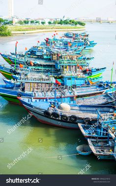 many colorful boats are docked in the water