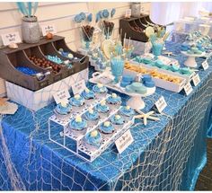 a table topped with lots of cupcakes and cakes