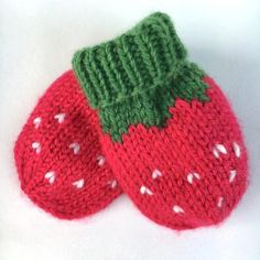 two knitted strawberries sitting next to each other