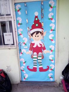 a door decorated with an elf and candy canes