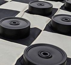 black and white checkered cloth with round objects on it's surface, in the shape of squares