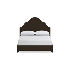 a bed with white pillows and brown headboard