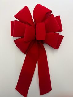 a large red bow on top of a white table