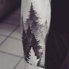 a man's leg with trees on it