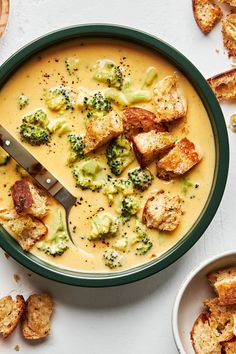 a bowl of soup with broccoli and croutons