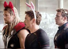 two men in costumes standing next to each other with bunny ears on their head and one man wearing an antman costume