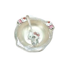 a hello kitty dish with two spoons in it