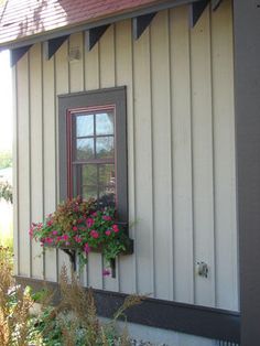 a house with flowers in the window box