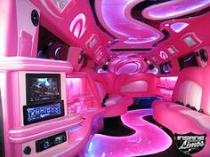 the interior of a pink limo with white leather seats and neon lights on the ceiling