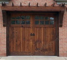 a wooden garage door with arched windows