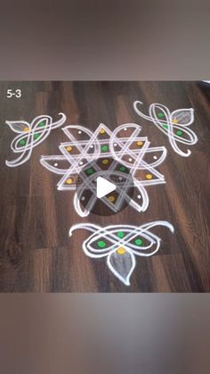 a wooden floor with some white and green designs on it