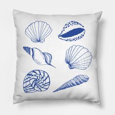 a blue and white pillow with shells on it