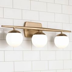 three lights on the wall in a bathroom