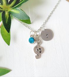 > Same day shipping available< Treble clef music note necklace for women, Custom music symbol gift. Personalize this music note necklace with a birthstone and hand stamped initial of your choice. This is a great gift for band members, friends in the band, also anyone who loves music, Music teacher gift, Gift for musician. How to order 1) Choose an Initial 2) choose a Birthstone 3) Add to cart Handmade with love and care Jewlery Care tips Do not pull or tug on charms Take jewelry off when s Music-themed Metal Jewelry For Gifts, Silver Music-themed Round Jewelry, Silver Music-themed Necklace For Gift, Nickel-free Music-themed Jewelry As Gift, Personalized Music-themed Necklaces For Anniversary, Music-themed Charms Jewelry For Gifts, Music-themed Pendant Necklaces As Gift, Music-themed Charm Jewelry As A Gift, Music-themed Charms Jewelry As Gift