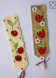 two handmade bookmarks with cherries on them, one is red and the other is white