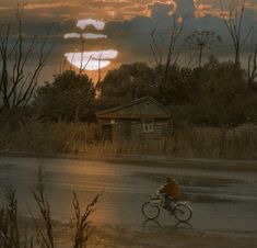 a man riding a bike down a rain soaked road