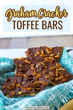 chocolate graham cracker toffe bars on a blue towel with pecans in the background