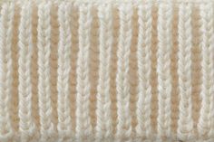 a white knitted headband is shown in close up