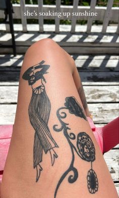 a woman's leg with a tattoo on it