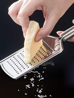 a person grating cheese with a grater