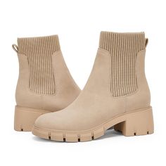 a pair of beige boots with chunky soles on the bottom and heeled toes