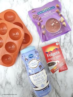 ingredients to make chocolate pudding laid out on a marble counter top with muffin tins