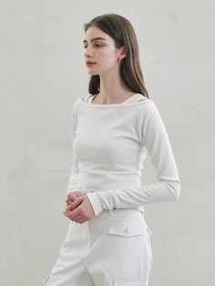 This product, the Cotton Layered Top, features a classic design with a modern twist. The layered look adds depth to the simple silhouette, while the pure cotton fabric ensures comfort and breathability. Perfect for transitional weather, this top combines versatility and style with its long sleeves and subtle textural contrast. - Crafted from soft cotton, this top is comfortable for all-day wear and easy to care for.- The layered design adds an element of sophistication to an otherwise basic piece.- Long sleeves make it an ideal choice for cooler days or layering under jackets and blazers.- Its simple elegance makes it a versatile piece that can be dressed up or down for various occasions. Classic Everyday Spring Tops, Minimalist Cotton Tops For Spring, Modern Spring Tops For Everyday Wear, Classic Spring Tops With Minimal Stretch, Minimalist Long Sleeve Tops For Spring, Minimalist Long Sleeve Spring Tops, Minimalist Tops For Spring Layering, Modern White Tops For Layering, Modern White Tops For Spring