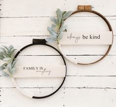 two hoop wreaths with leaves and words on them