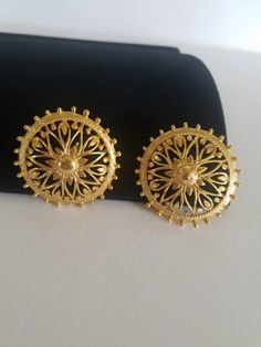 "A pair of vintage filigree large clip-on earrings. One little \"spoke\" is missing. Please see photos. Sold as is. Priced accordingly. Does not include any props in photos. Please feel free to contact me with any questions you may have. Before you buy, please note that the items in my shop are pre-owned and may (or may not) have some signs of wear (scratches, scuffs, pulls, etc) due to their age. Any very noticeable defects or marks will be noted in the descriptions. Please read FAQs and store Vintage Round Earrings With Intricate Design, Vintage Filigree Earrings For Anniversary, Vintage Filigree Clip-on Earrings For Formal Events, Vintage 14k Gold Clip-on Earrings For Anniversary, Vintage Clip-on Plug Earrings As Gift, Vintage Filigree Clip-on Earrings For Formal Occasions, Antique Yellow Gold Clip-on Earrings As Gift, Ornate Filigree Clip-on Earrings As Gift, Ornate Gold Filigree Clip-on Earrings