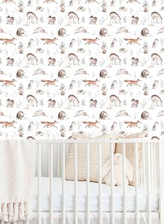 a baby crib with a wallpaper pattern on it and a bed in the foreground