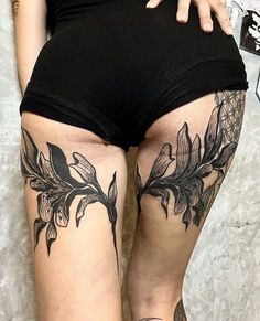 a woman in black shorts with tattoos on her legs