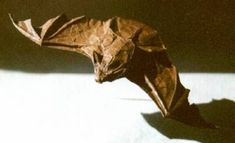 a brown origami bat sitting on top of a table