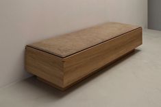 a wooden bench sitting on top of a white floor