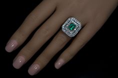 Circa 1910s - early 1920s This very well made antique platinum and 14K gold ring features an emerald cut emerald of an excellent bluish green color. The emerald is set in a yellow gold bezel and framed by two rows of bright white old mine cut diamonds (F-G color, SI clarity). The diamonds are set in platinum over gold. The emerald measures 8 x 5.9 x 3.8 mm and is approximately 1.24 ct. Estimated combined diamond weight is 2.10 ct. The emerald and diamond cluster measures 21 x 19 mm (13/16 x 6/8 Art Deco Green Jewelry With Brilliant Cut, Gia Certified Oval Emerald Ring In Art Deco Style, Art Deco Platinum Emerald Ring Gift, Art Deco Platinum Emerald Ring As Gift, Vintage Hallmarked Emerald Ring In Platinum, Art Deco Platinum Emerald Ring As A Gift, Vintage Green Emerald Ring Gia Certified, Timeless Emerald Ring With 17 Jewels For Formal Occasions, Art Deco Diamond Emerald Ring Octagon Shape