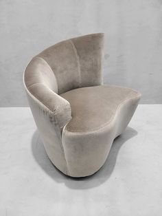 a gray chair sitting on top of a white floor