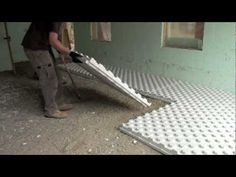 a man is working on the floor in his house with a tile sawing machine