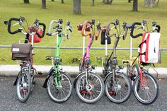 several bicycles parked next to each other in front of a fence