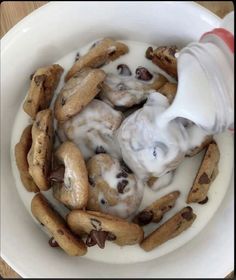 a bowl filled with cookies and cream being drizzled on top of it