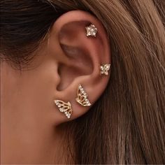 a woman's ear with three different types of piercings