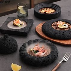 four black plates with different types of food on them