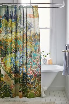 a bathroom with a bathtub, shower curtain and rug