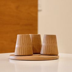 two small brown vases sitting on top of a white table