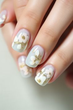 Embrace subtle elegance with these sophisticated floral nails featuring soft white flowers and gold accents on a pastel background. These nails are perfect for enhancing your look with a touch of floral charm. Visit nailhow.com for more cute and simple spring nails! Grad Nails, Silk Wrap Nails, Simple Spring Nails, Nail Prices, Sns Nails, Floral Nail Designs, Floral Nail, Cuticle Care, Nail Oil