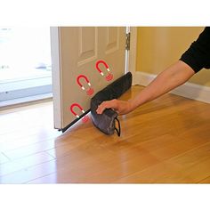 a person is holding an umbrella on the floor with red handles and hooks attached to it