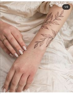 a woman's arm with leaves on it