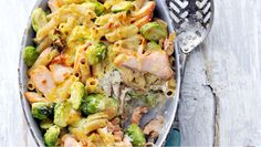 a bowl filled with pasta and vegetables on top of a table