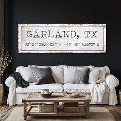 a living room filled with furniture and a large sign above the couch that says garland, tx