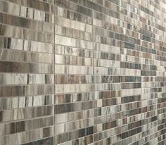 a bathroom with a tiled wall next to a toilet