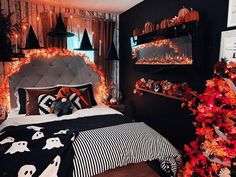 a bedroom decorated for halloween with pumpkins and lights