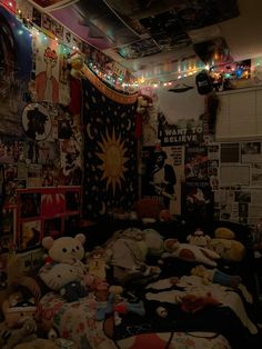 a room filled with lots of stuffed animals and lights hanging from the ceiling above it